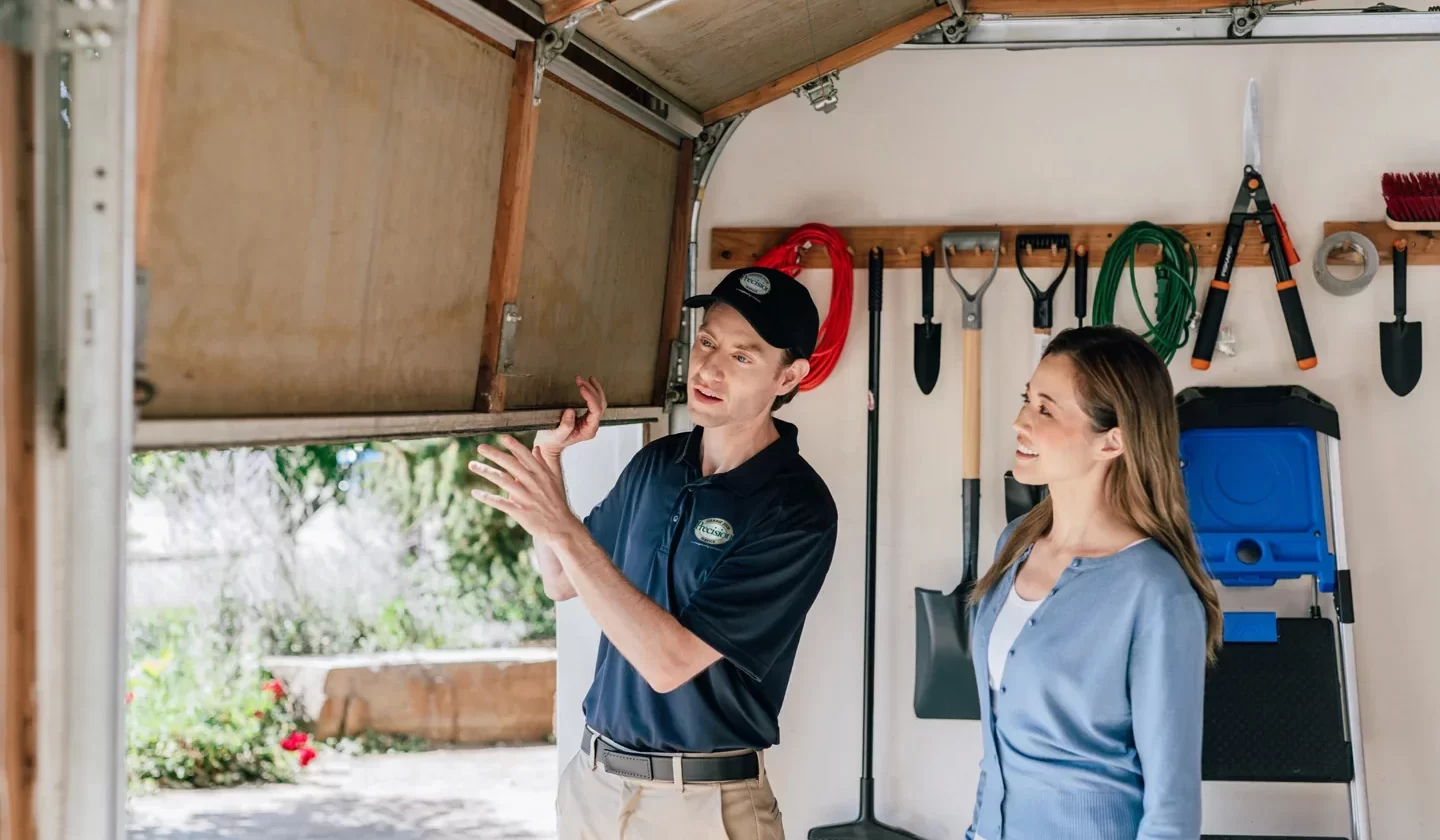 Precision Garage Door technician helping customer with garage door repairs