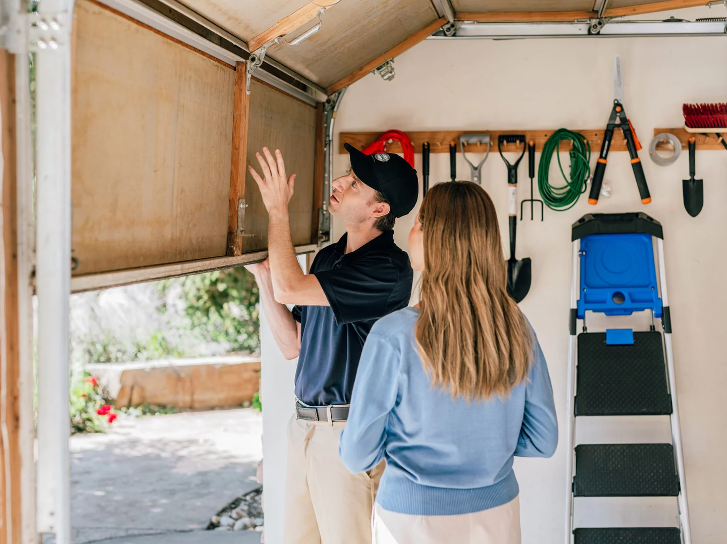 Precision technician inspecting one of the types of garage door bottom seals