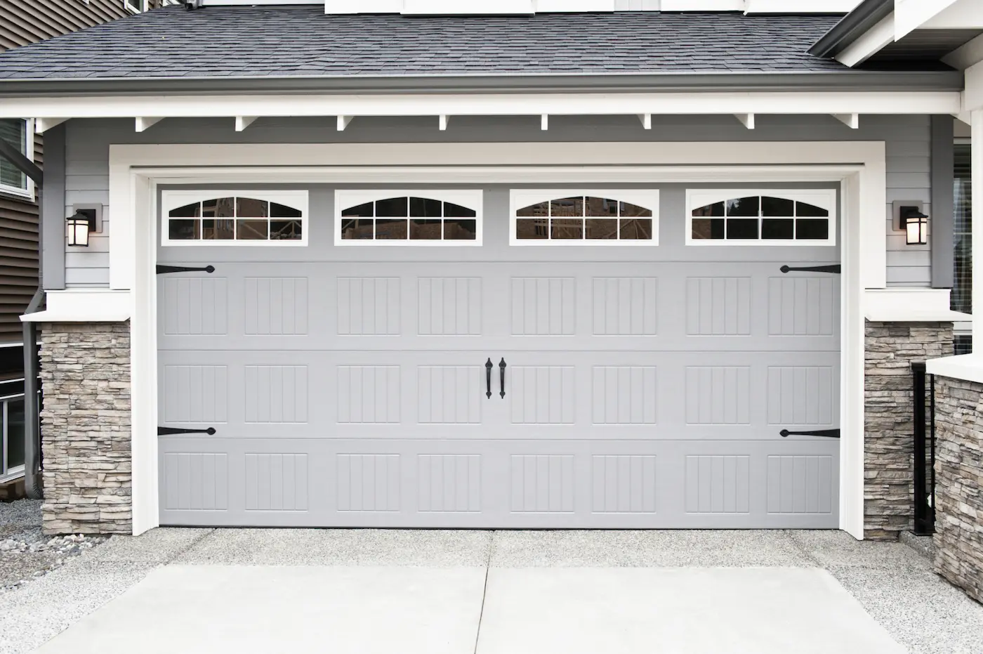 Gray garage door with decorative hardware
